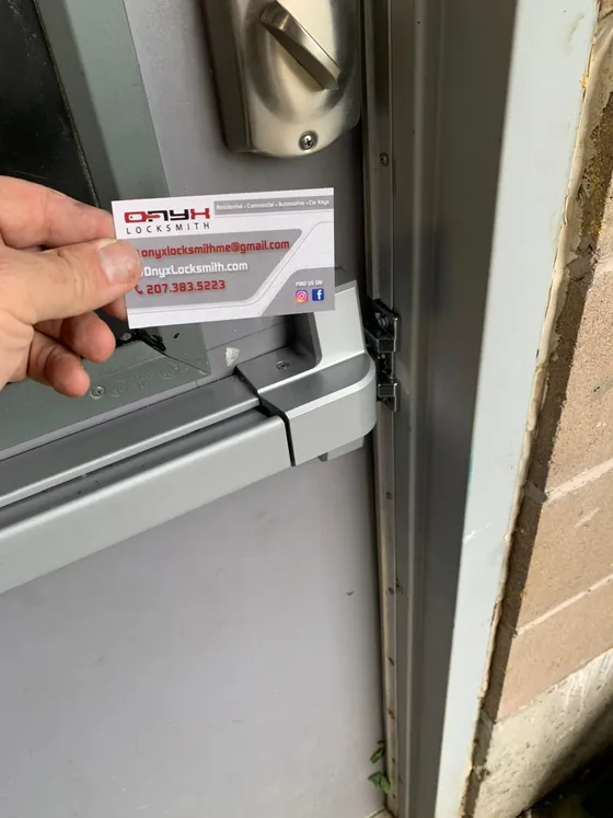 A deadbolt on a door edge, with an Onyx card