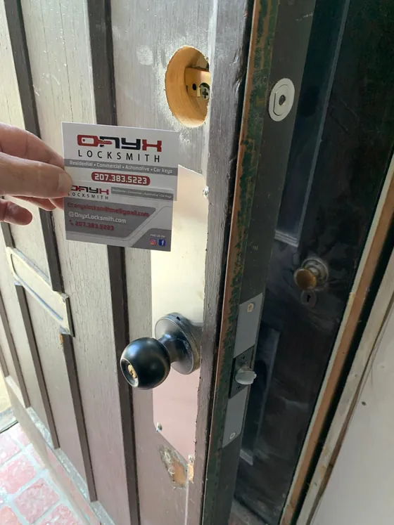 A door mid lock change: the old deadbolt out, a new knob fitted