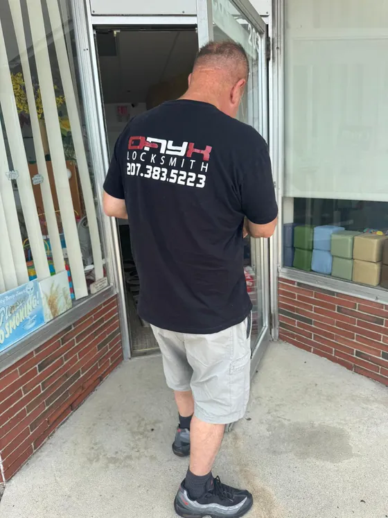 An Onyx technician at a store's glass entrance door
