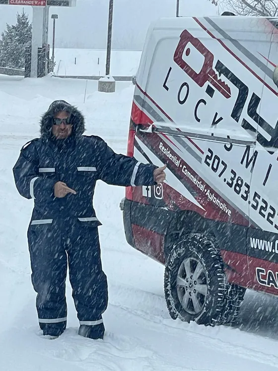 An Onyx technician beside his van in a snowstorm