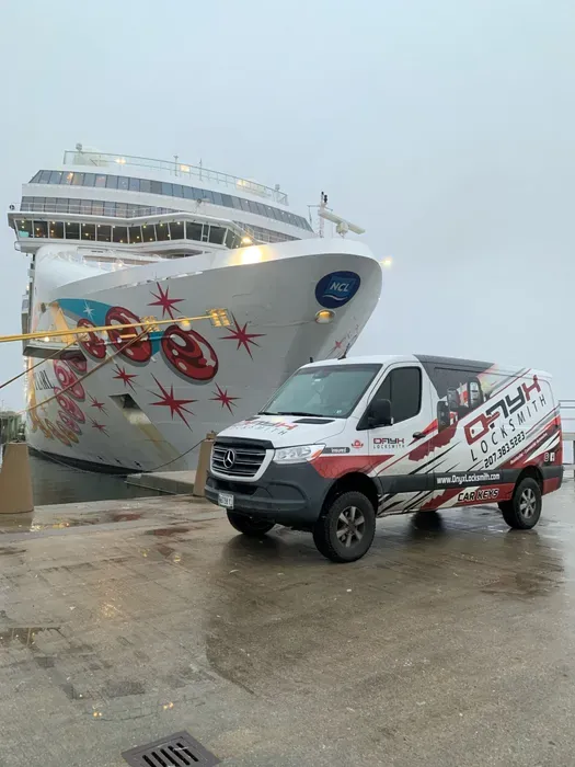 An Onyx van beside a cruise ship at the terminal