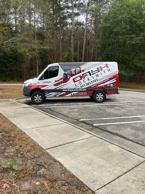 An Onyx van parked by the woods