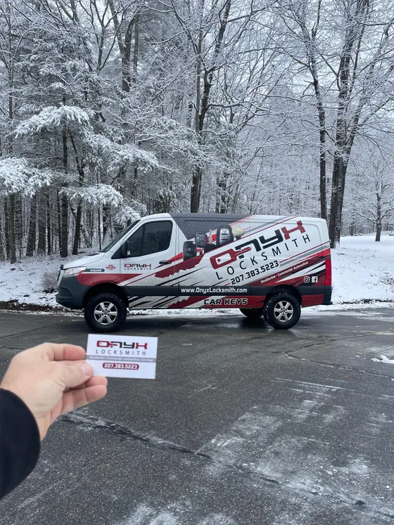 An Onyx van in a snowy lot, card in hand
